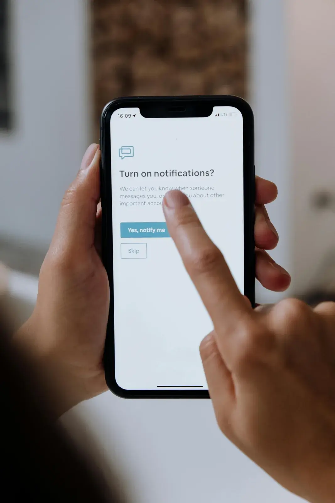 User browsing a mobile-responsive website on smartphone to check design and functionality