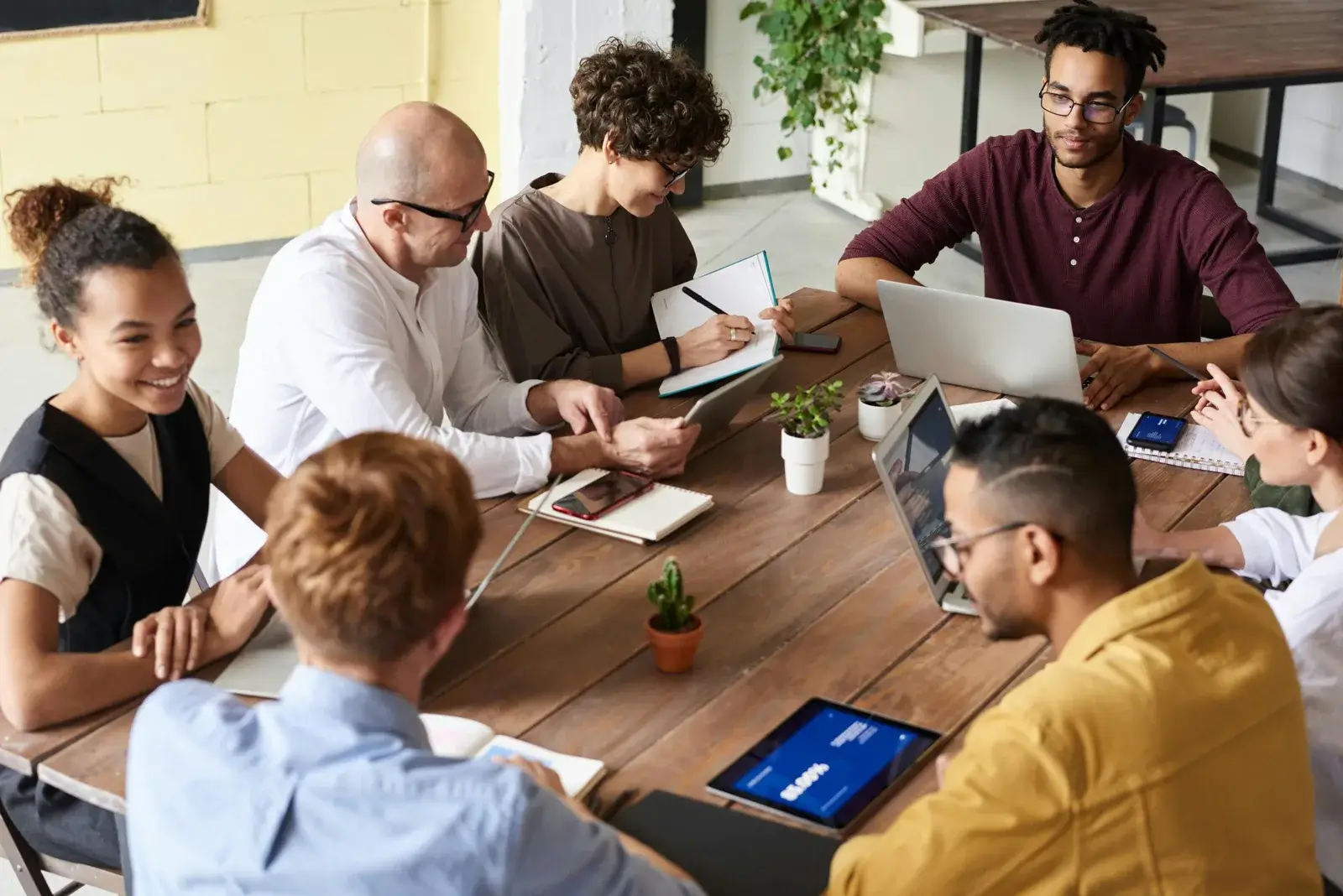 Team collaborating around table for content marketing strategy and planning